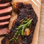 NY strip garlic butter steak on a cutting board