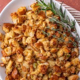 turkey stuffing on a serving platter with a spring of rosemary