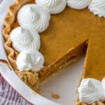 a 10 inch pumpkin pie with one slice cut out