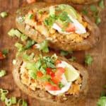 two mexican baked potatoes on a baking sheet