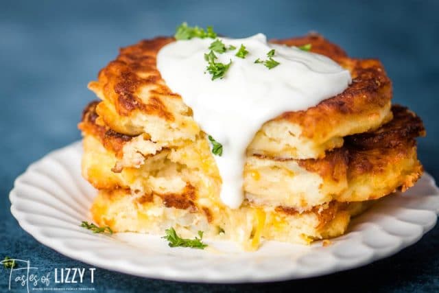 stack of 3 fried potato cakes with sour cream