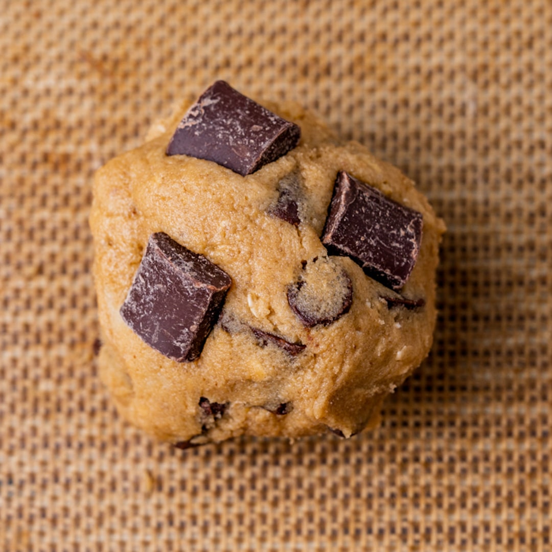 a cookie dough ball on a silicone baking mat