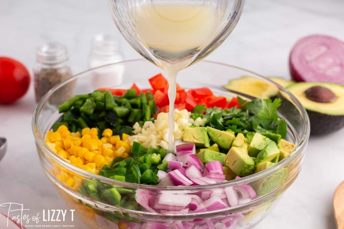 juice pouring over fresh vegetable salad