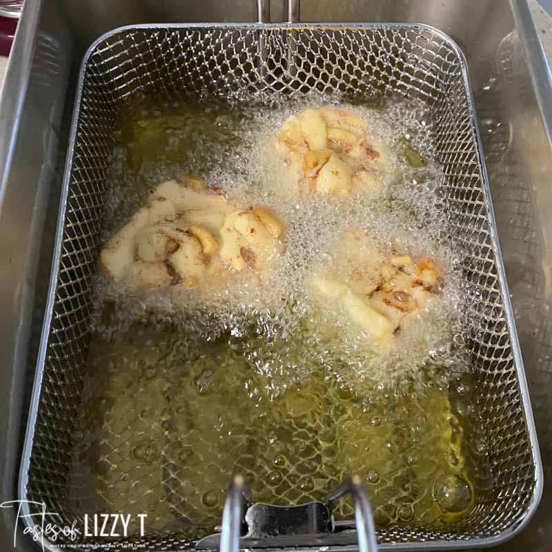 apple fritters in a deep fryer