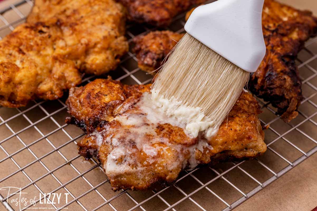 pastry brush brushing butter on chicken