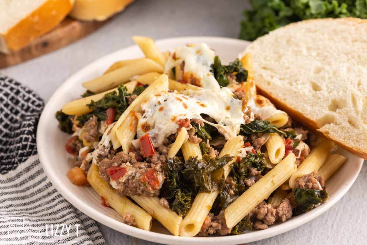 a plate of kale tomato skillet lasagna with bread