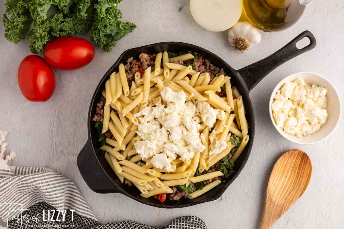 fresh mozzarella over pasta in a skillet