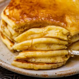 closeup of cornmeal pancakes with a bite cut out