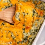 spinach mashed potatoes with a wooden spoon