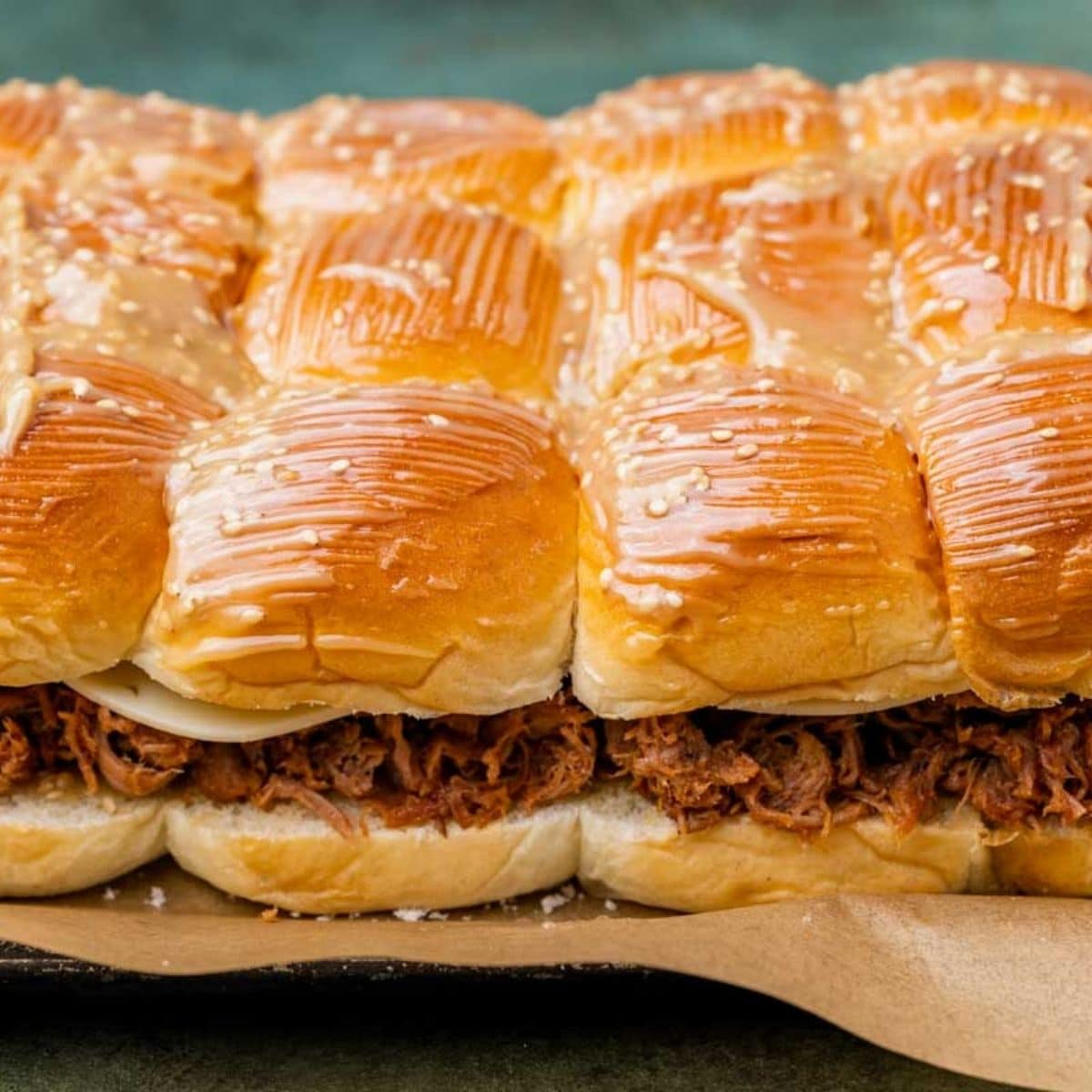 unbaked pulled pork sliders on a baking sheet