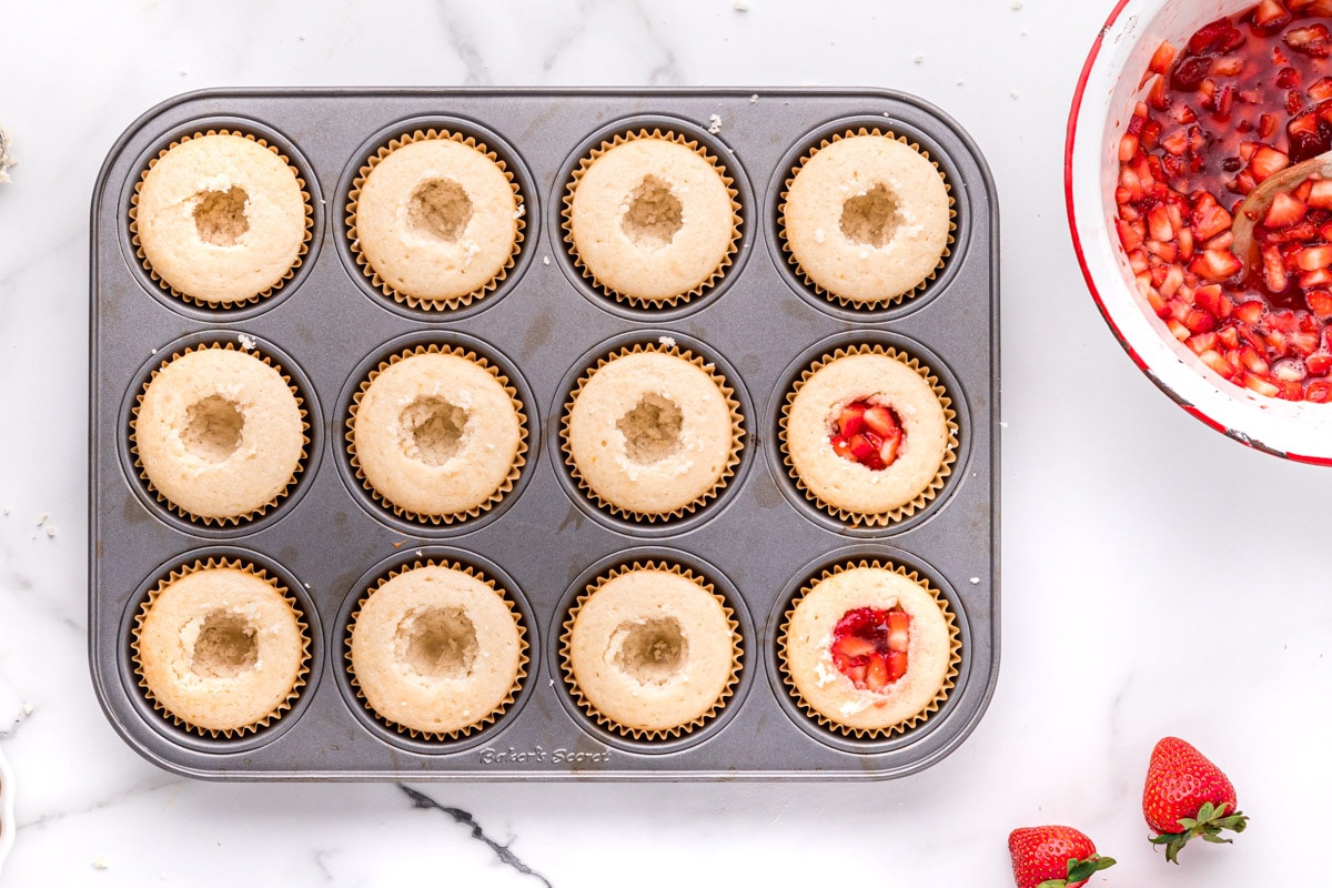 vanilla cupcakes with holes in them for strawberries