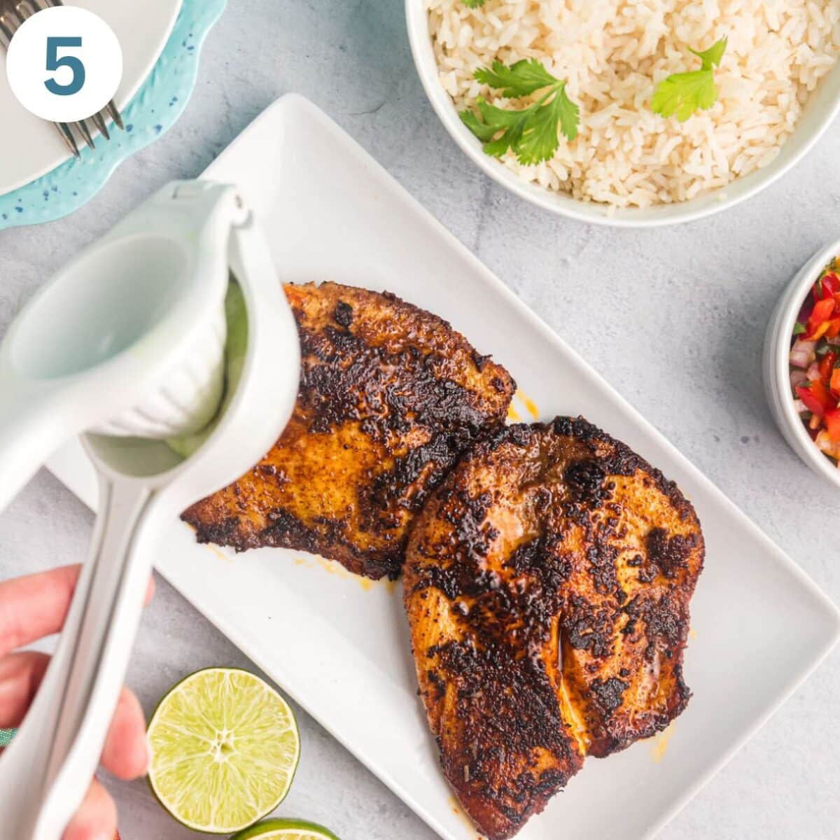 squeezing lime juice on fried tilapia