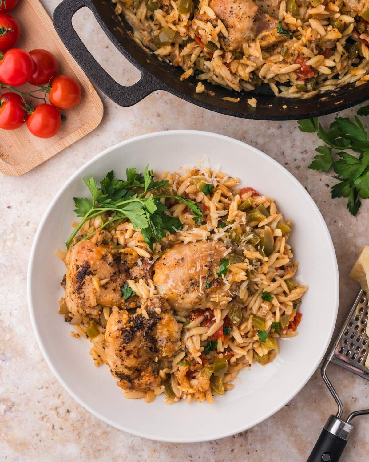 chicken and orzo on a plate with fresh parmesan
