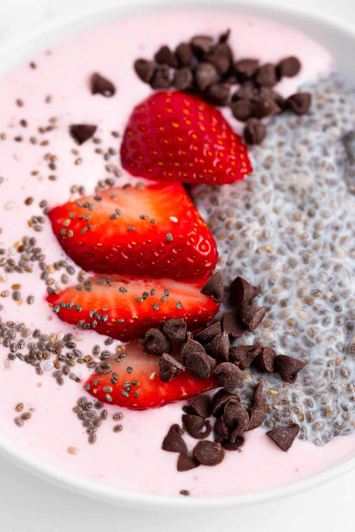 closeup of a smoothie bowl with chia seeds and strawberries