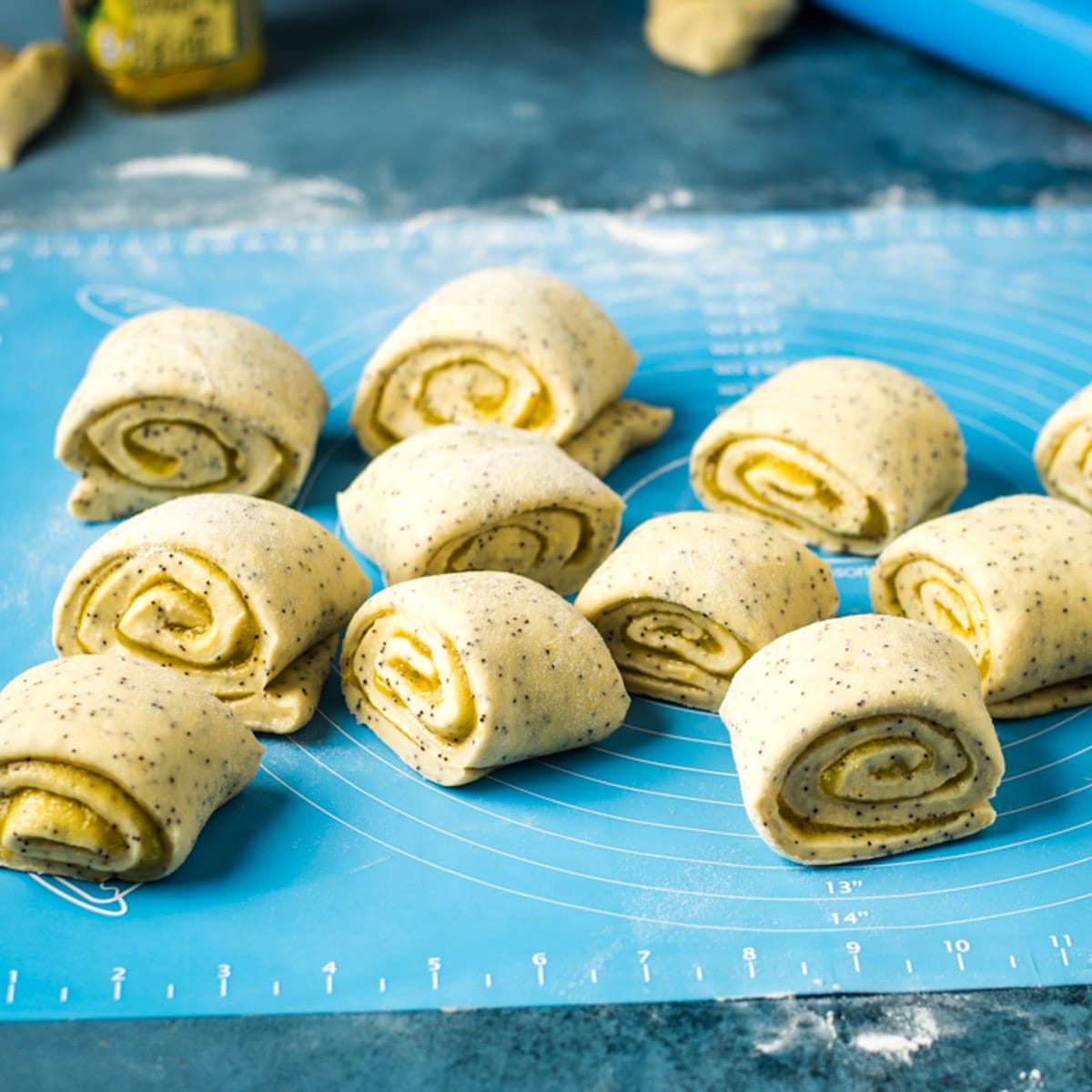 lemon poppy seed rolls on a baking mat
