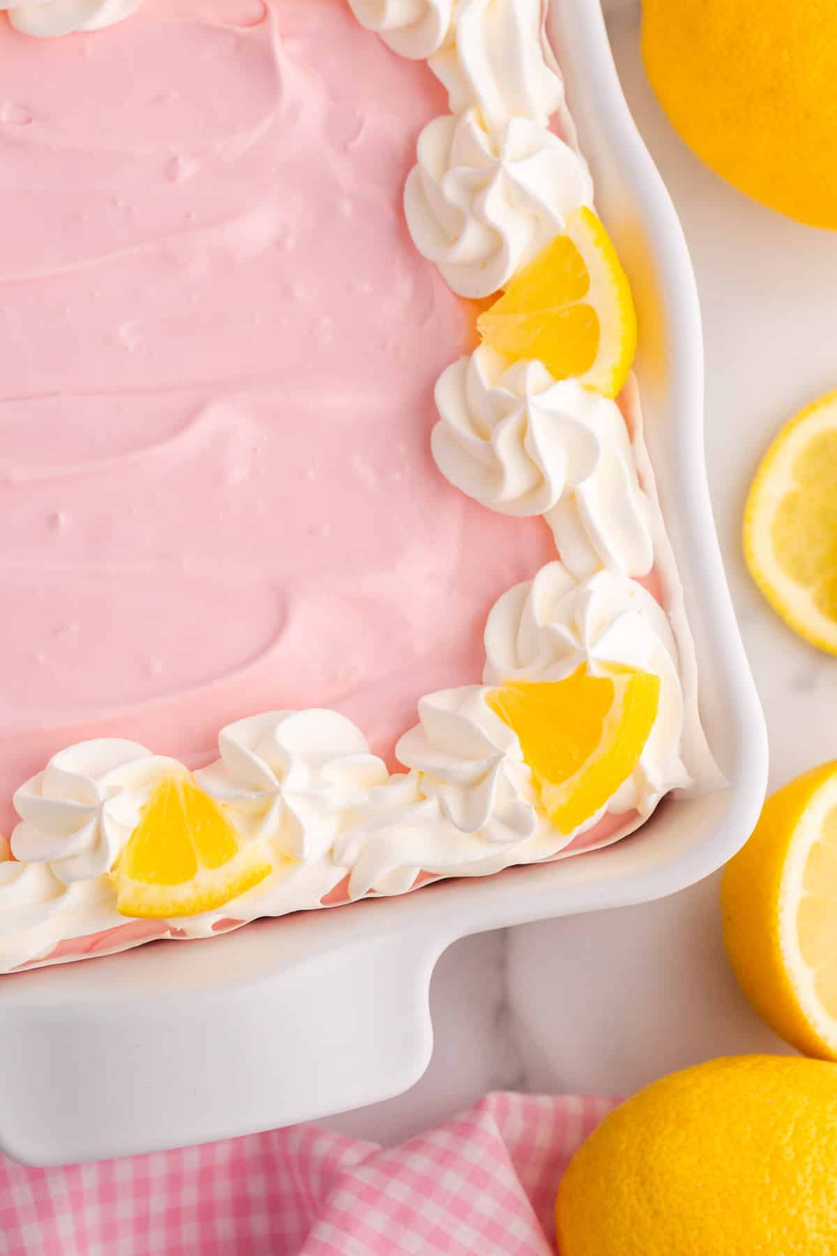 overhead view of pink lemonade pie squares in a pan