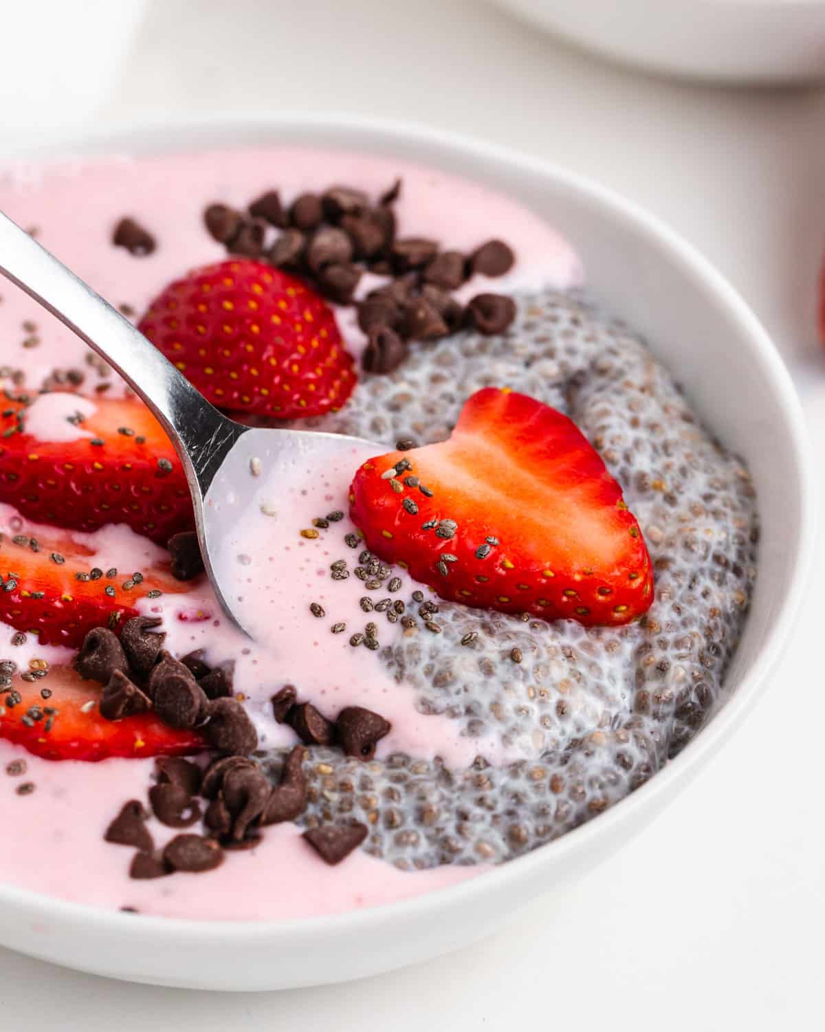 chia smoothie bowl with a spoon on a table