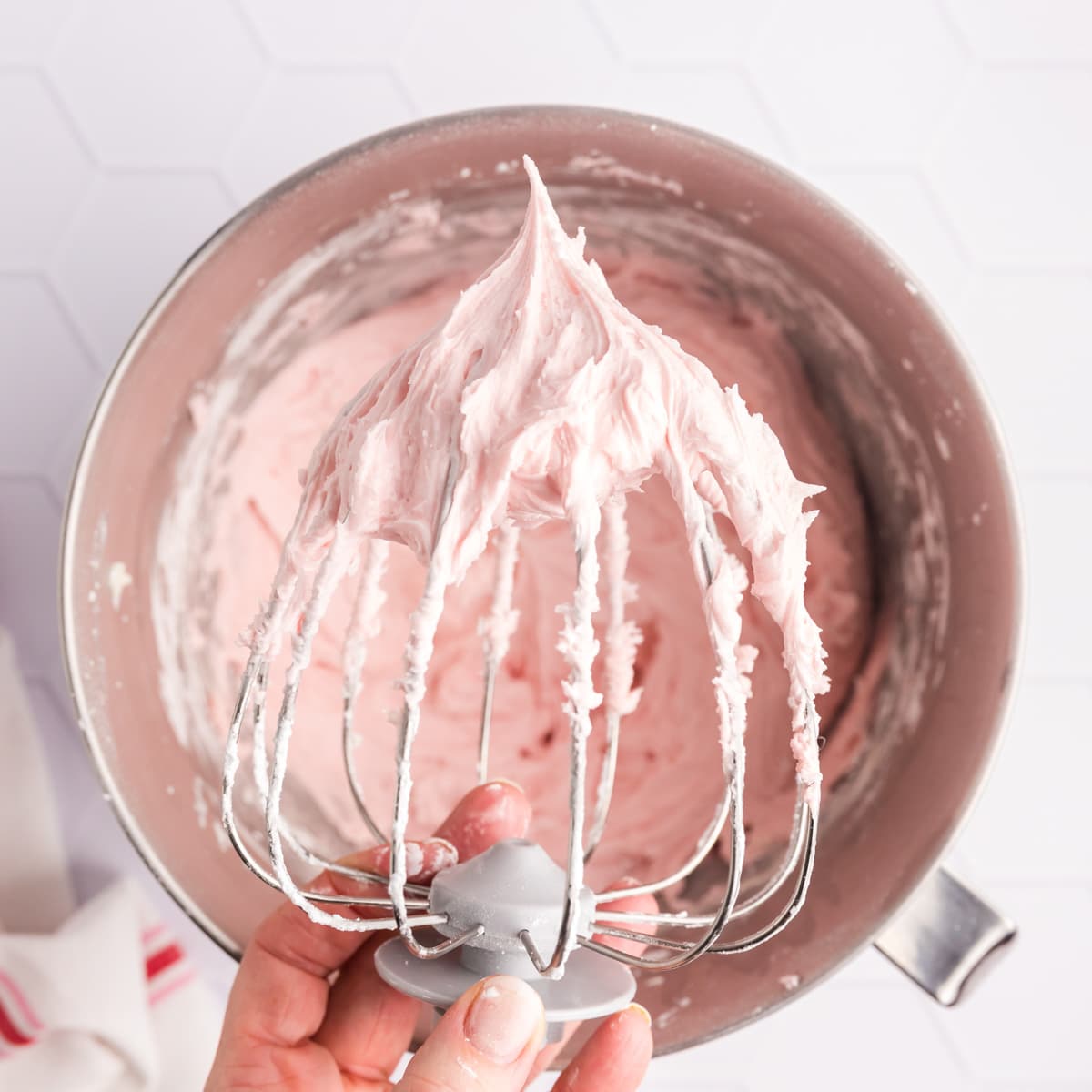 strawberry frosting on a whisk