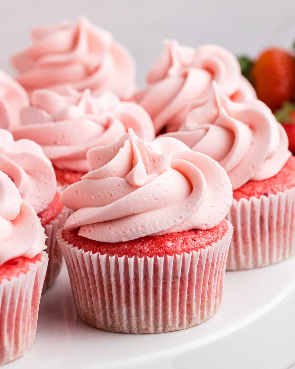 strawberry cupcakes with strawberry frosting swirled on top