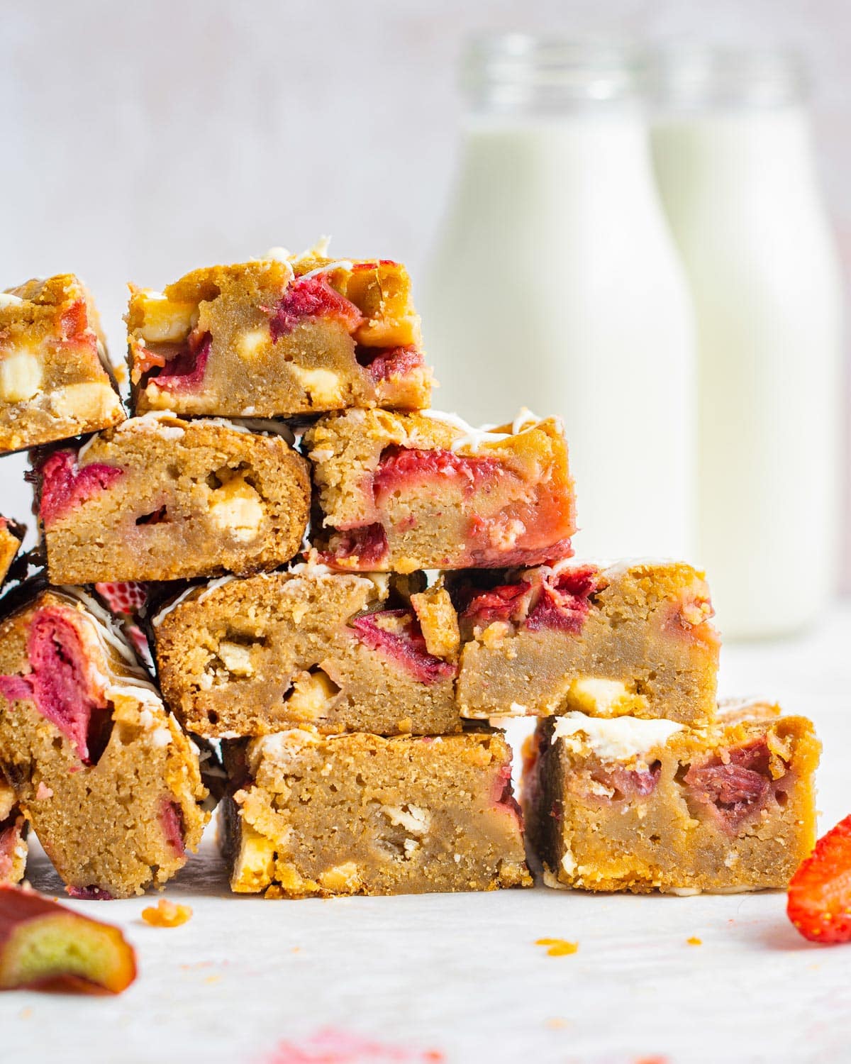 a stack of cookie bars with rhubarb and strawberries