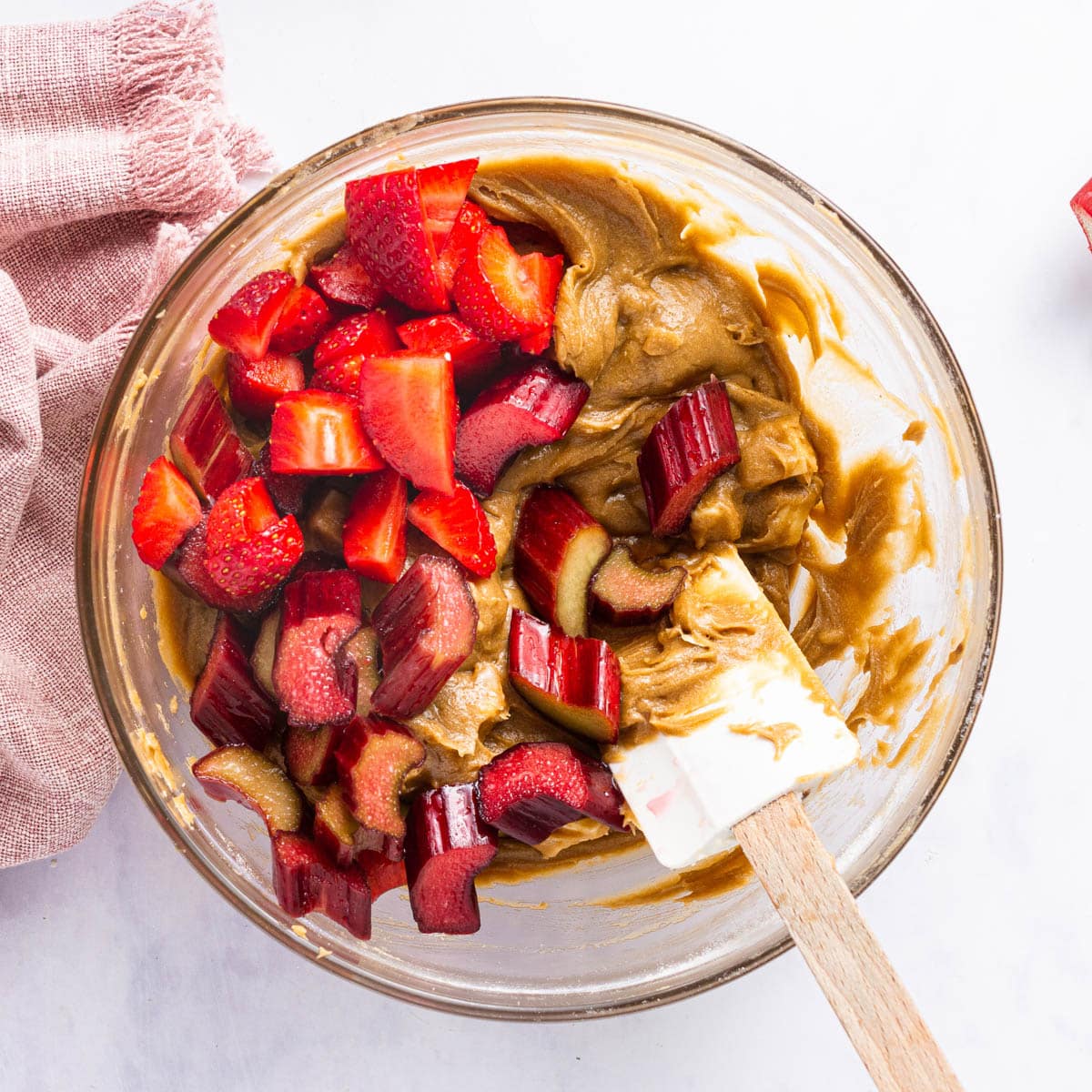 mixing strawberries and rhubarb into cookie dough
