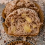 half of an apple cinnamon muffin on a baking pan