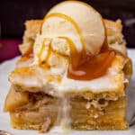 a piece of apple pie bars with ice cream and caramel