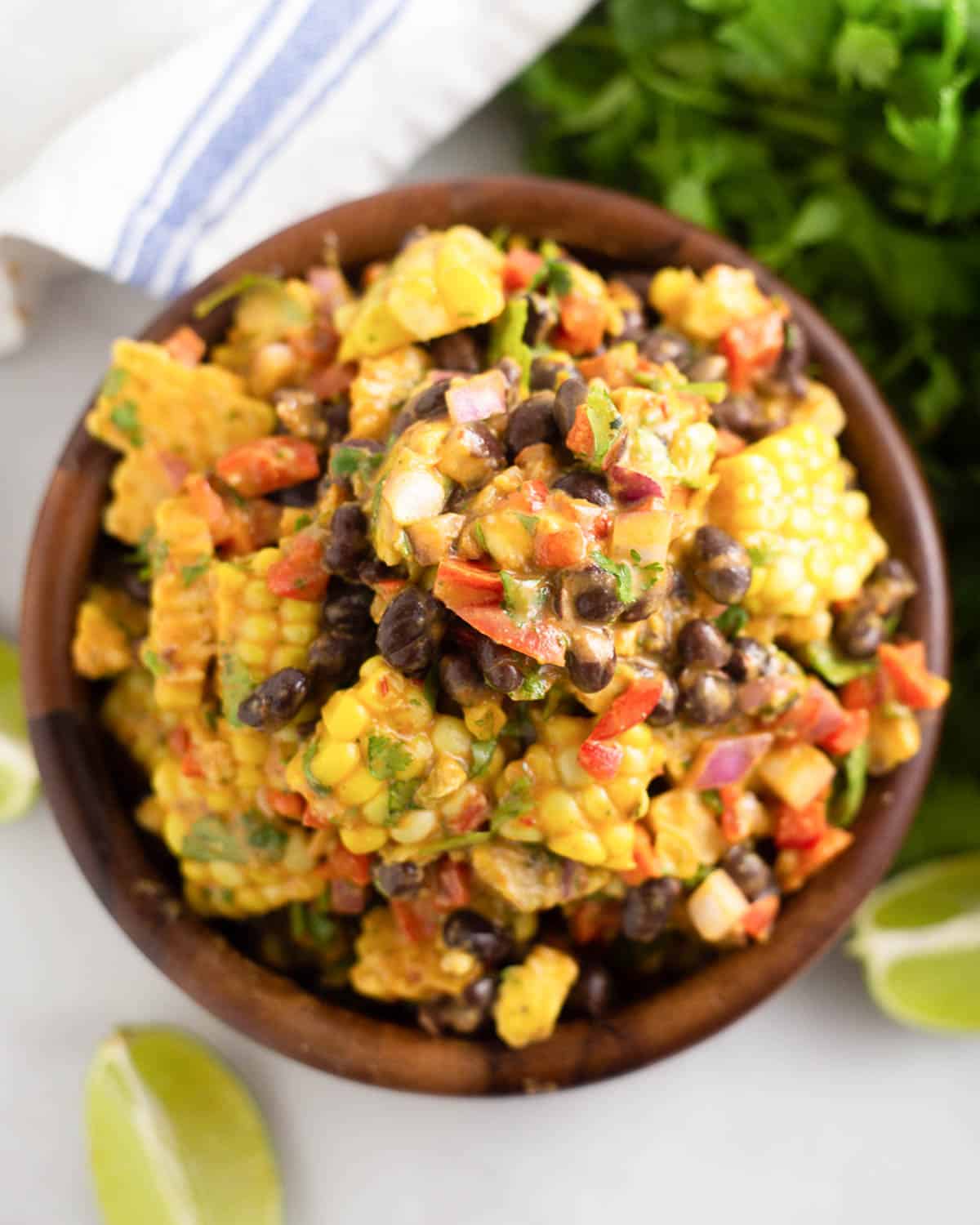 black bean and corn salad with honey lime dressing in a wooden bowl