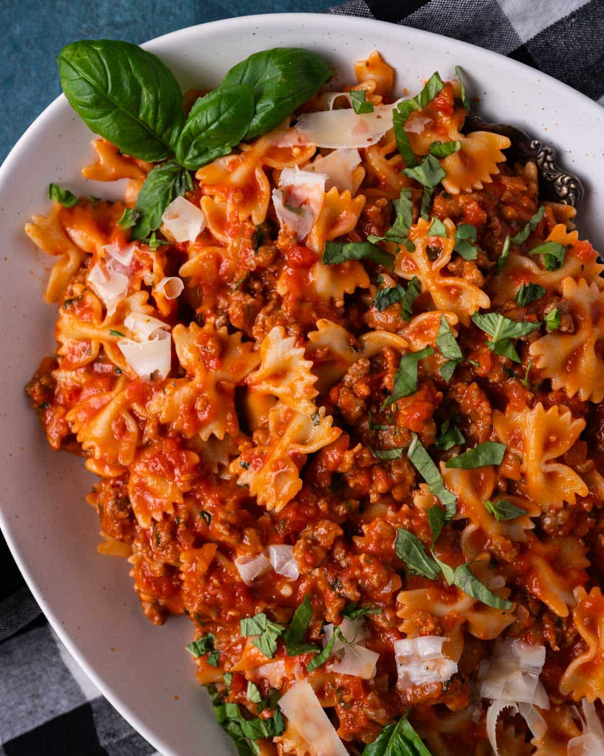 a plate of bowtie pasta with sausage