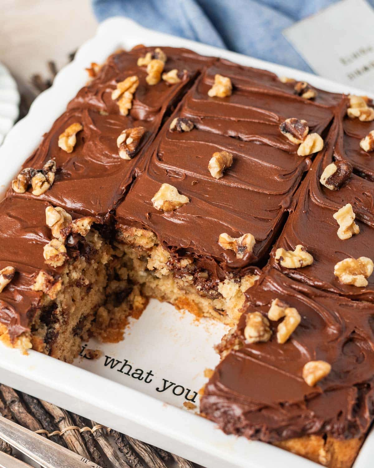 chocolate chip snack cake with chocolate frosting and walnuts on top