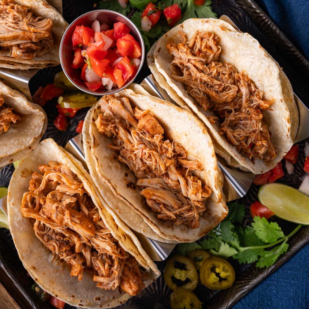 overhead view of chicken tacos with shredded chicken