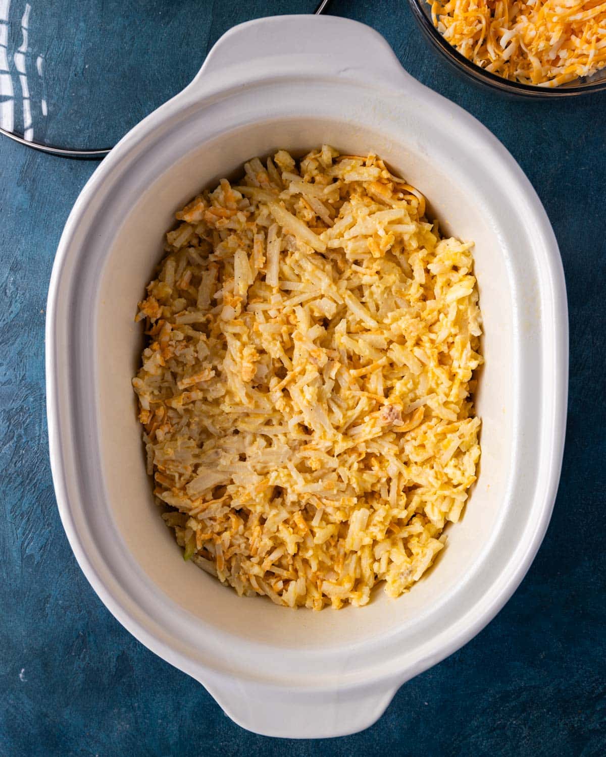 uncooked hashbrown casserole in a crockpot