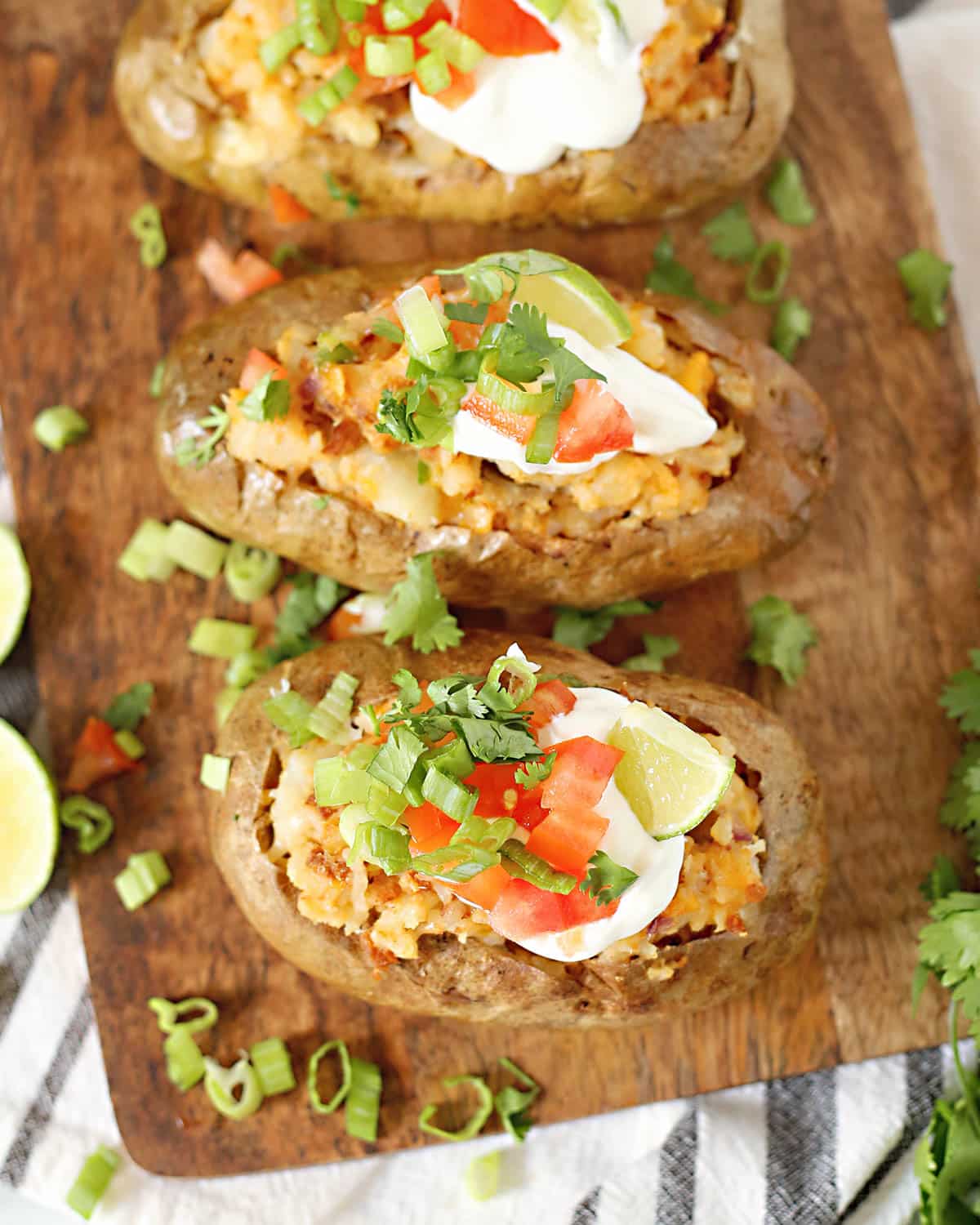 mexican baked potatoes on a cutting board