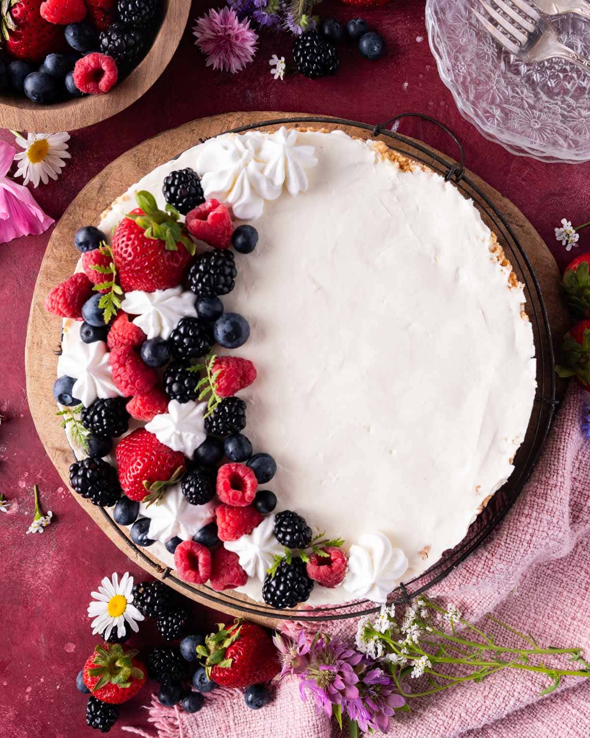 overhead view of a no bake cheesecake with fresh berries on top