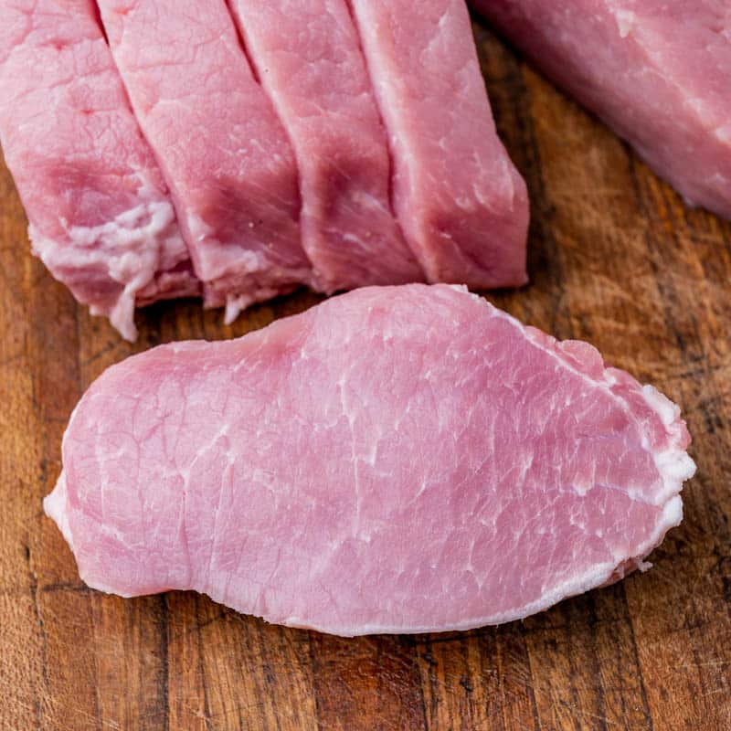 pork loin chops on a cutting board