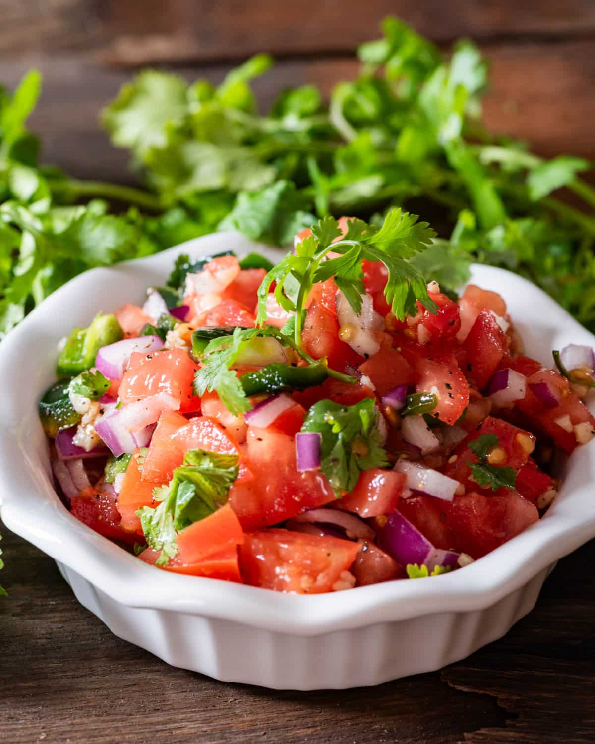 a bowl of fresh salsa with cilantro on top