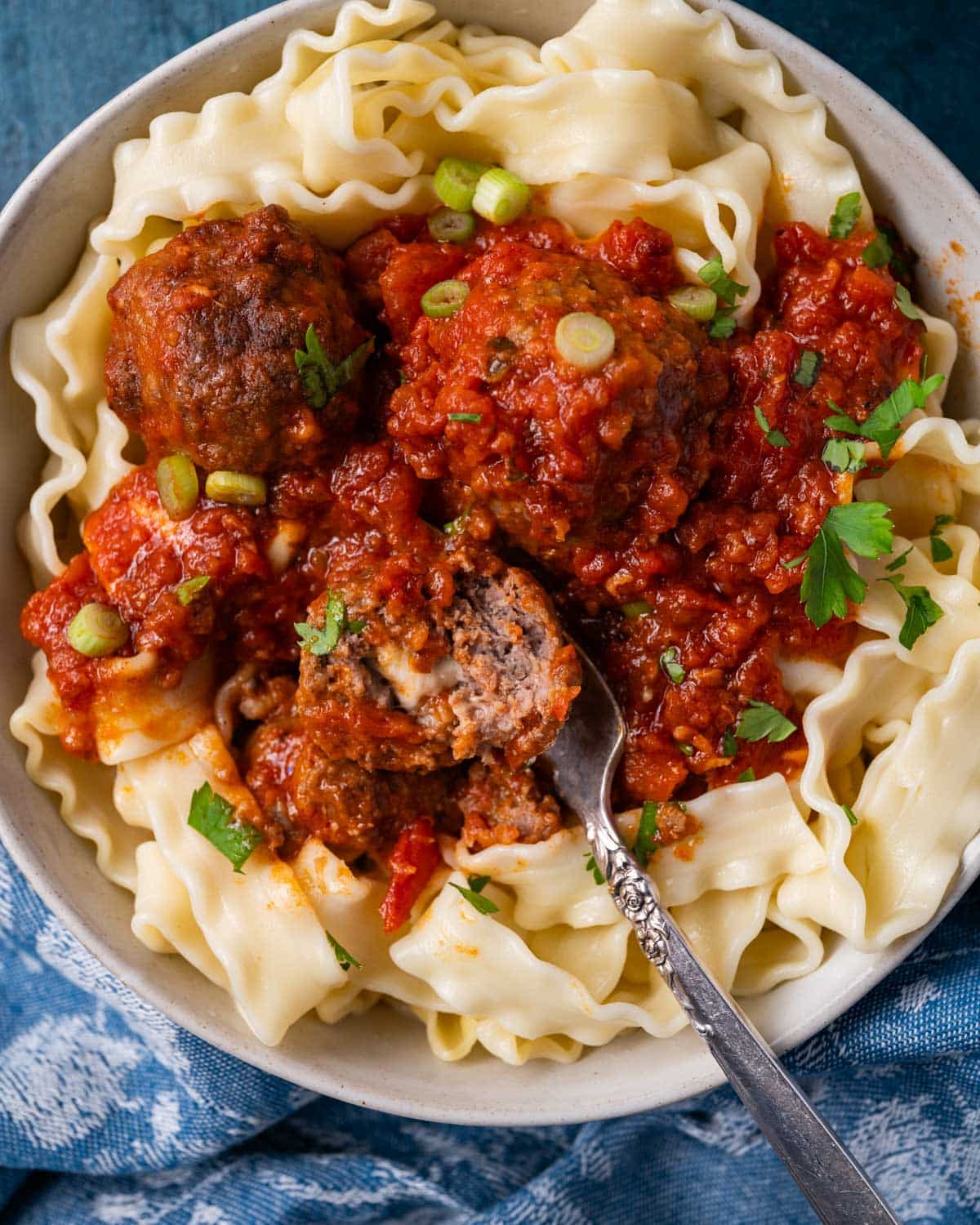 meatballs over pasta in a bowl