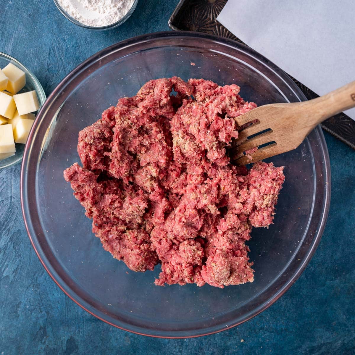ground beef meatball mixture in a glass bowl