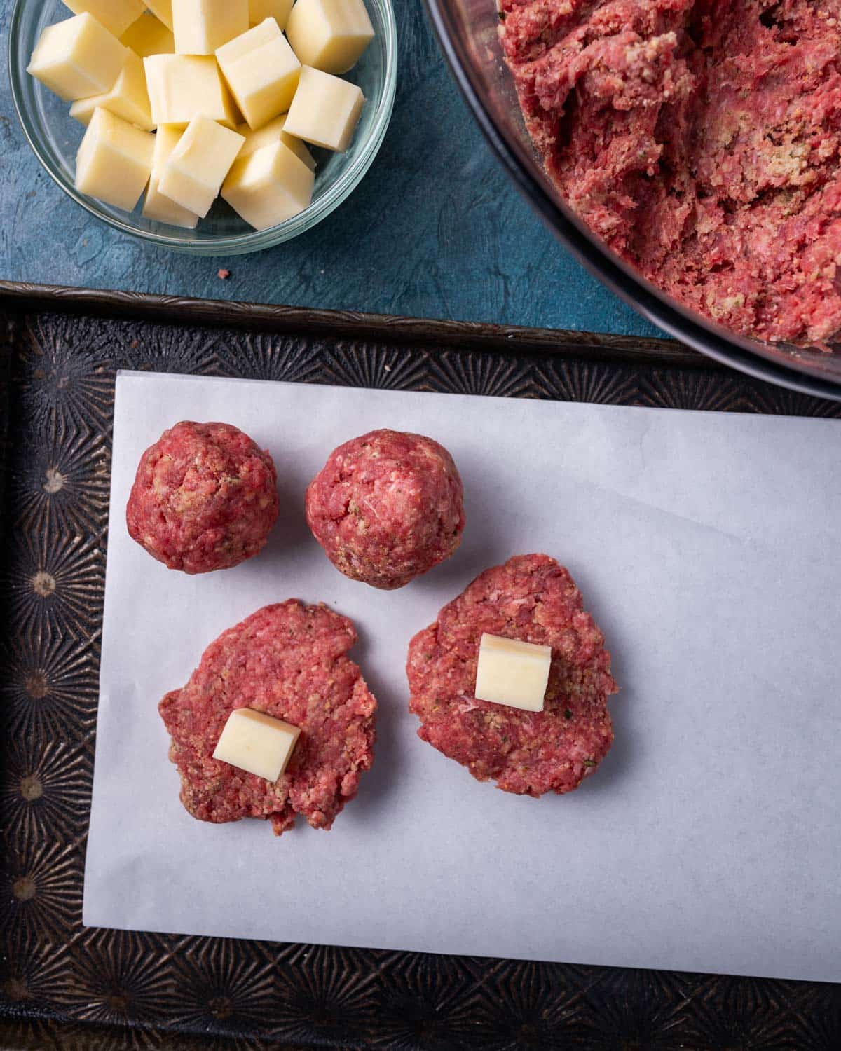 placing cheese cubes inside meatballs