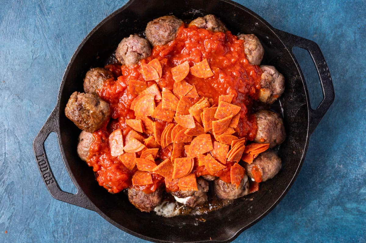 meatballs with spaghetti sauce and pepperoni in a skillet