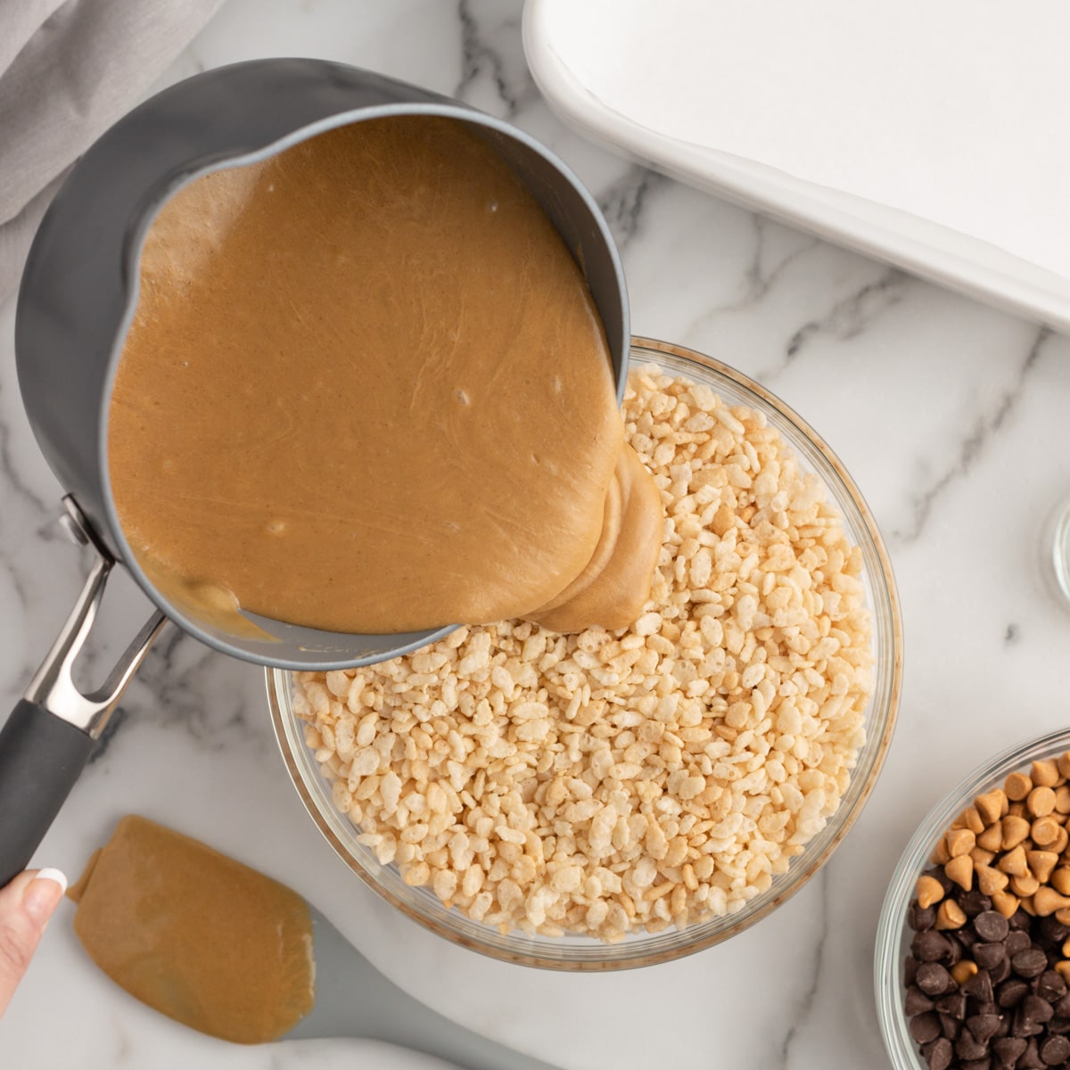 caramel sauce pouring over crisped rice cereal
