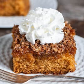 amish breakfast cake with whipped cream on a plate