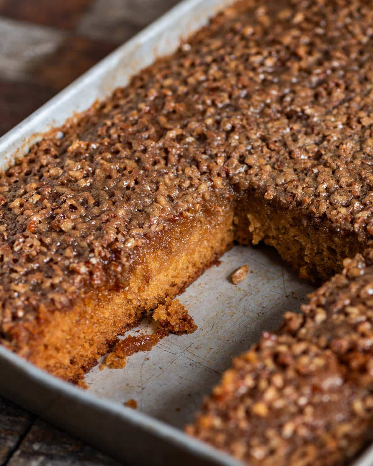 a pan of amish cake with walnut topping in a cake pan