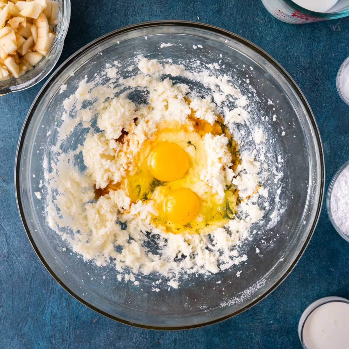 creamed butter and sugar with two eggs on top in a bowl
