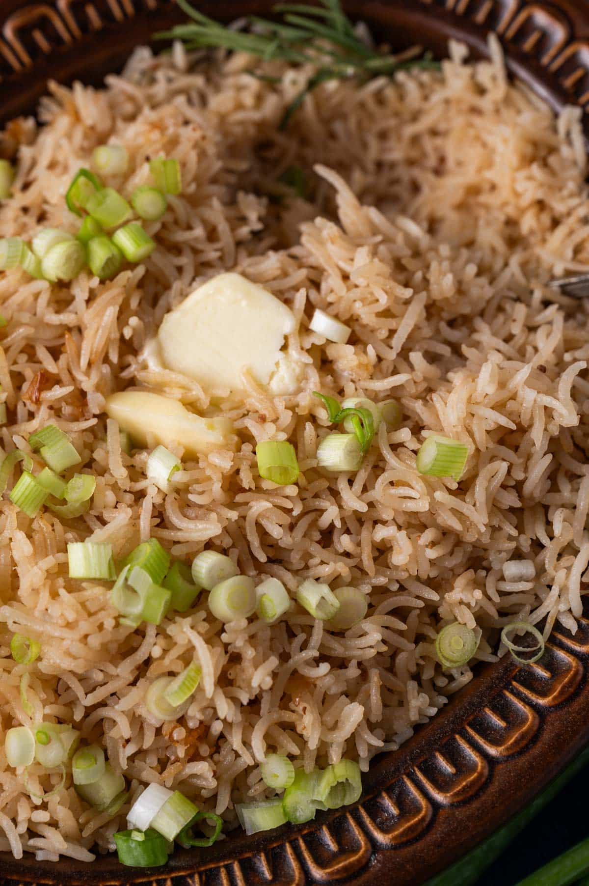 rice with butter and green onions on top