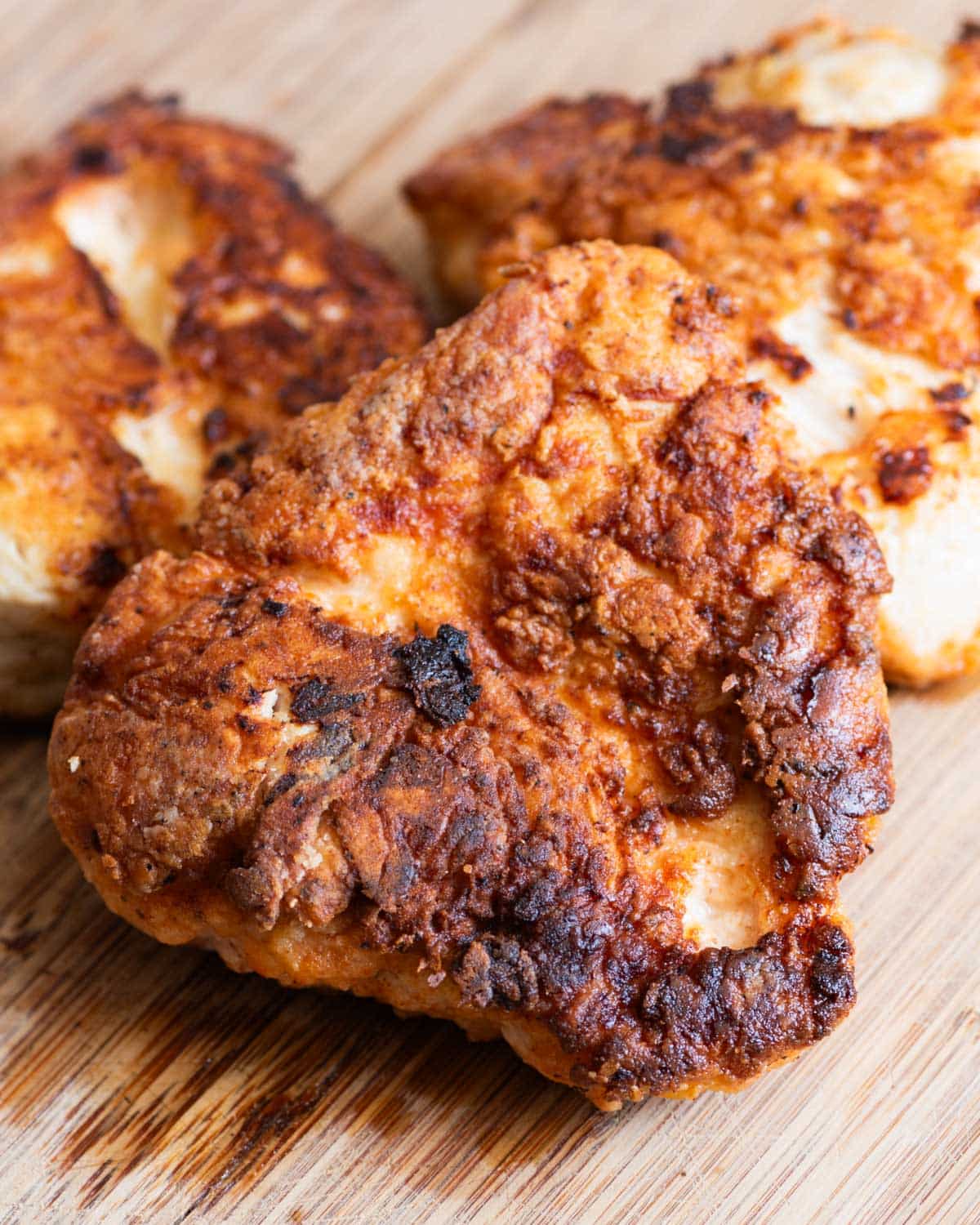 pieces of buttermilk fried chicken breasts on a table