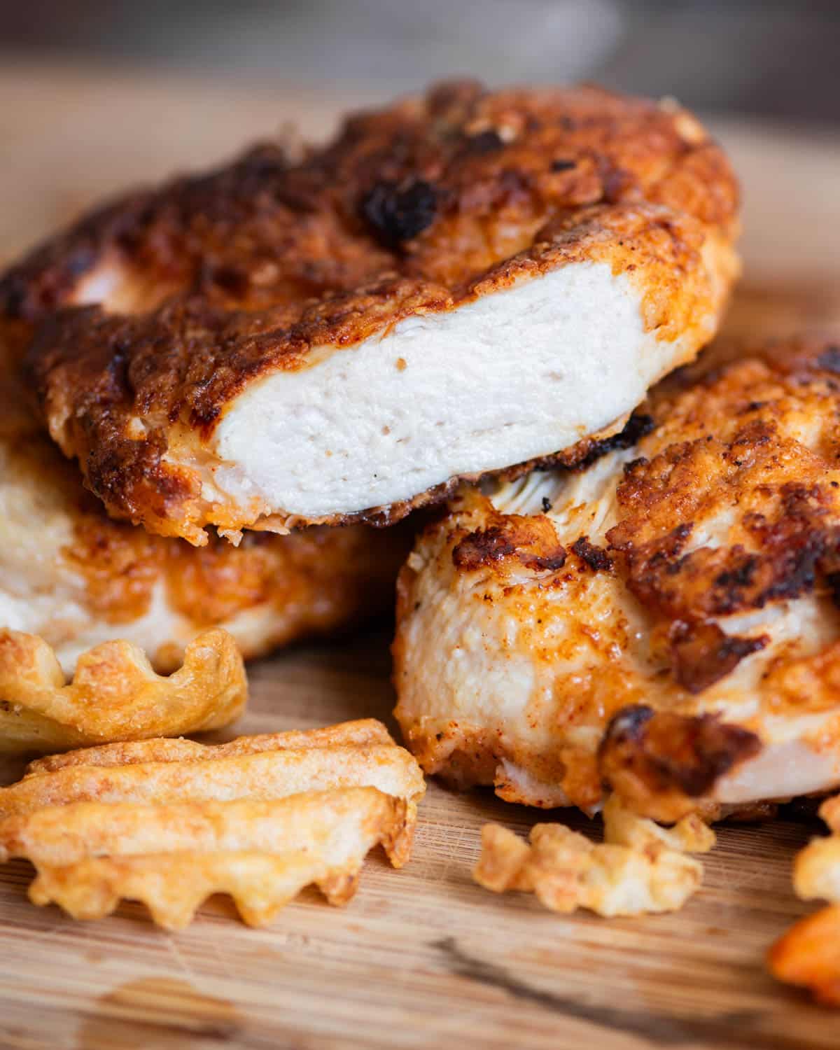 a piece of buttermilk fried chicken with a bite cut out