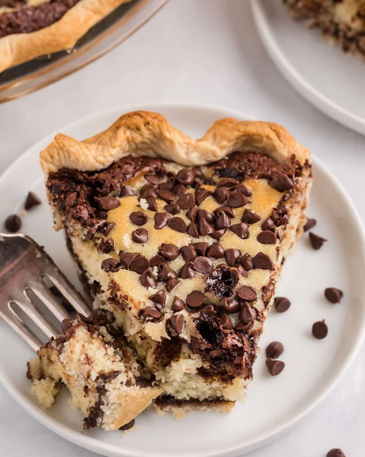overhead view of a slice of cake pie with chocolate chips on a plate