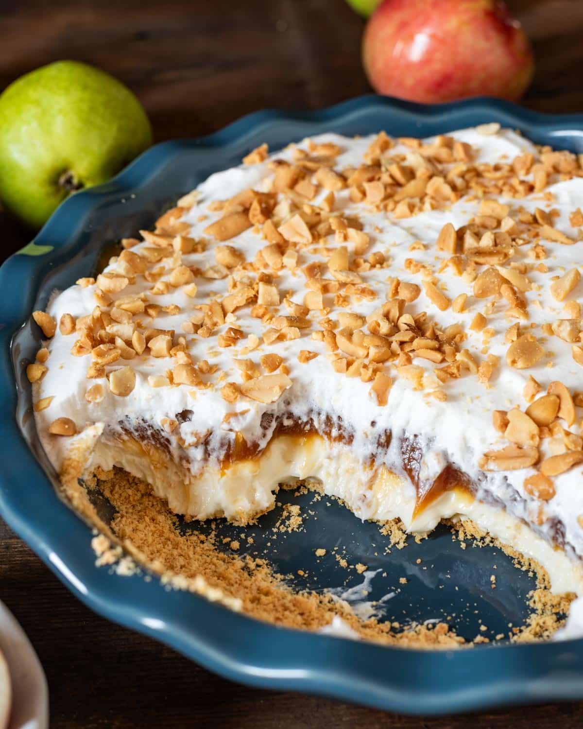 caramel apple cheesecake in a pan with half of it gone