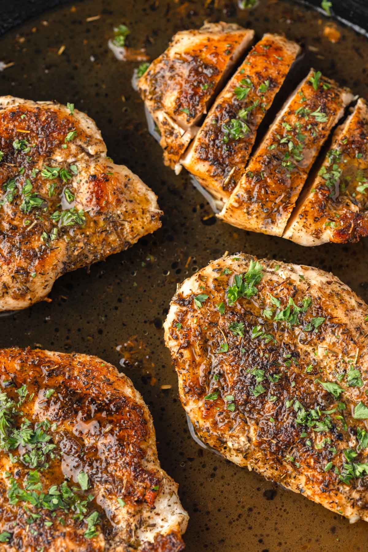 Herbed chicken breasts in a cast iron skillet